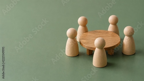 Teamwork Concept with Wooden Figures around a Table