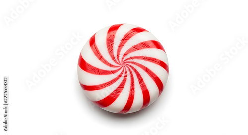 A single round peppermint hard candy with red and white spiral stripes isolated on white background
