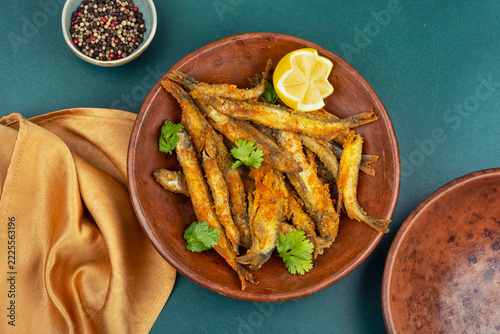 Traditional breaded capelin with lemon wedges