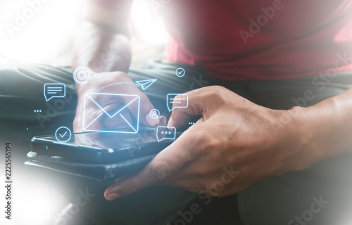 Man using smartphone with email and messaging digital communication icons
