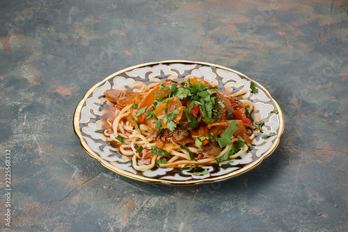 A plate of spaghetti pasta topped with tomato sauce meat and fresh