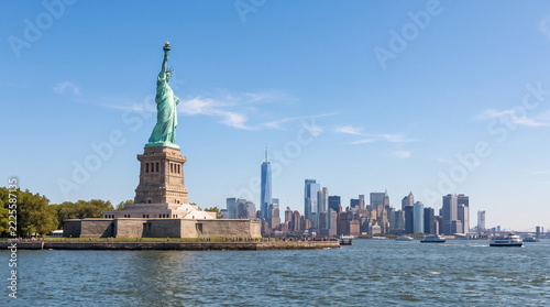 Statue of Liberty on Liberty Island with Manhattan Skyline and Waterfront. Concept of new york, new york city, new york harbor, nyc, travel. Copy space.