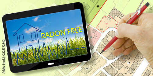 DANGEROUS RADIOACTIVE RADON GAS IN CITIES, RADON FREE HOMES, INDOOR AIR QUALITY, HEALTH RISKS, RADIATION DETECTION AND PREVENTION CONCEPT WITH IMAGINARY CADASTRAL CITY MAP AND DIGITAL TABLET