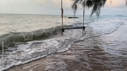 Empty swing over the water on the seaside