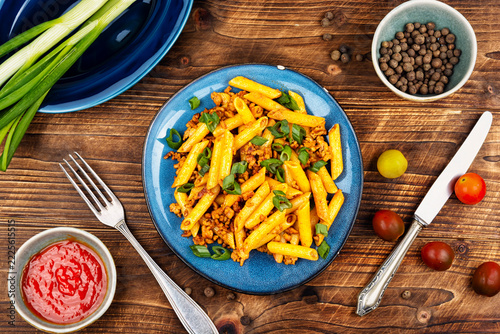Penne pasta with fried minced meat and green onion