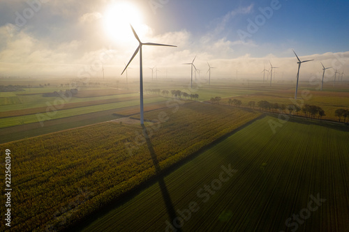 Wind turbines in a rural field during sunrise