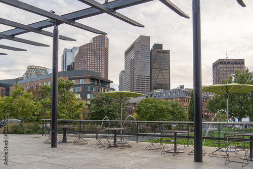 Boston skyline viewed from North End Park, part of the Rose Fitzgerald Kennedy Greenway, with a distinctive steel pergola in the foreground, Massachusetts, USA