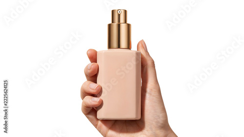 Hand holding cosmetic bottle with golden pump dispenser during studio lighting for beauty product advertisement