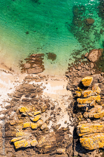 The beautiful French coastline along the Atlantic Ocean in Brittany, with rocks, azure water, and sand—a drone view.