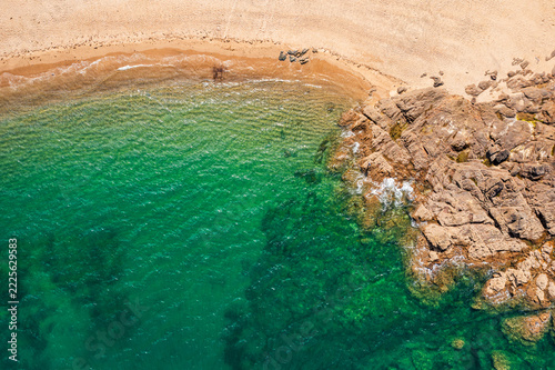 The beautiful French coastline along the Atlantic Ocean in Brittany, with rocks, azure water, and sand—a drone view.