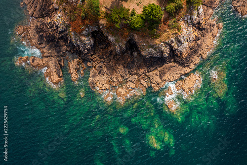 The beautiful French coastline along the Atlantic Ocean in Brittany, with rocks, azure water, and sand—a drone view.