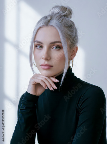 Woman with elegant bun wearing black turtleneck