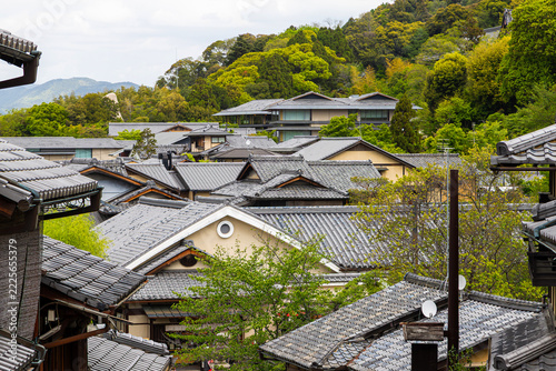 Traditional grey-tiled Japanese machiya townhouses and wave-like rooftops cascading across the historic Ninenzaka and Sannenzaka preservation district in Kyoto, Japan, some as old as 150 years old.