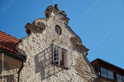 Baroque gable of the old historic medieval Swedish Gate building in Old Riga, Latvia. Vintage open window on a sunny day.