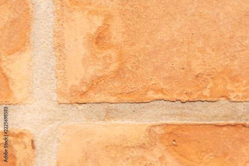 Terracotta clay tiles forming a textured surface with sandy grout lines
