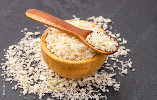 Panko-type breadcrumbs with a light, coarse texture, arranged in a bowl with a wooden spoon and space for text.