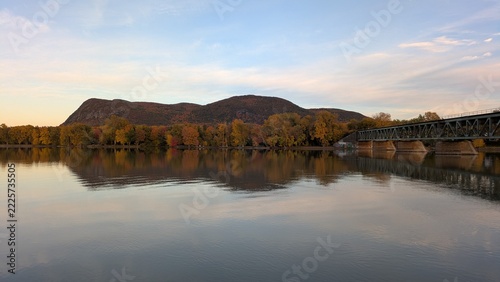Mont-St-Hilaire and railway bridge reflecting on Richelieu River