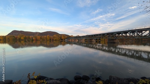 Mont-St-Hilaire and railway bridge reflecting on Richelieu River