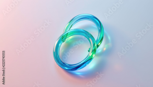 Intertwined Blue and Green Glass Rings Reflective Surface