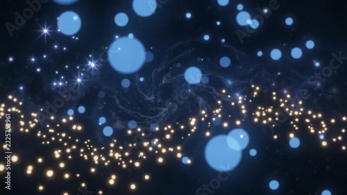 Gold particles abstract with blue bokeh floating in dark space