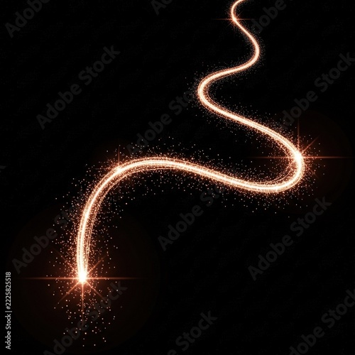 Golden light trail with sparkling dust particles on black background.