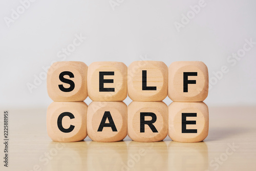 Fotografie Wooden block with self care text, representing health, wellness, mindfulness, and personal wellbeing concept