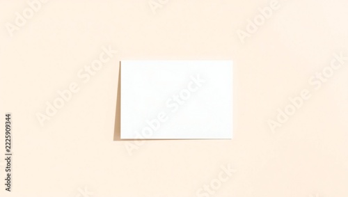Blank white paper card mockup on a soft beige background