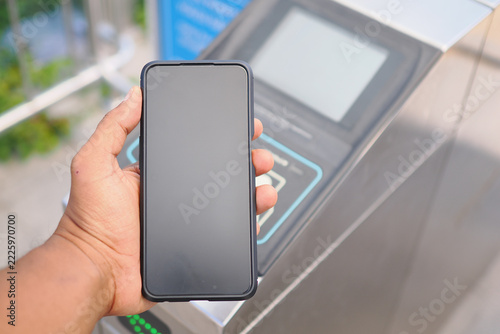 Obraz na plátně a person using a smartphone for contactless NFC scanning or QR code payment at a