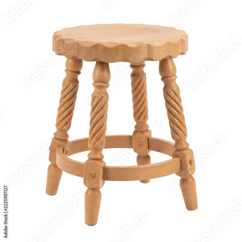 Carved beech wooden stool with a scalloped round seat, three spiral twisted legs and a ring stretcher with turned feet, isolated on transparent background