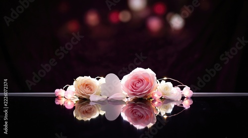 Pink Roses and Heart with Fairy Lights on Reflective Surface