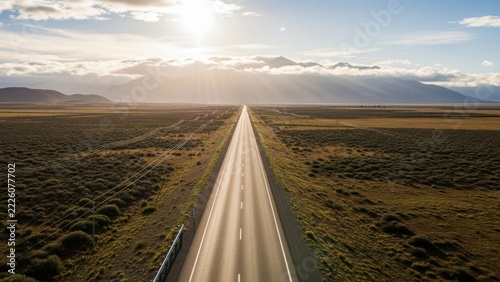 Long empty road through a flat green countryside
