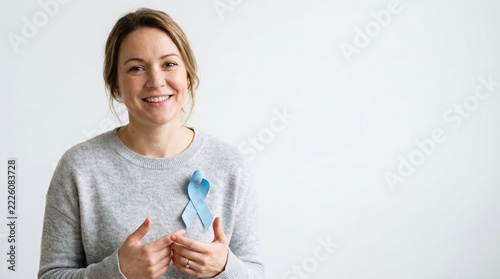 Woman Smiling with Blue Awareness Ribbon on Sweater Cancer Support and Health Awareness Concept