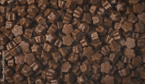 Dryed pet food in star shape. Panoramic background texture.	