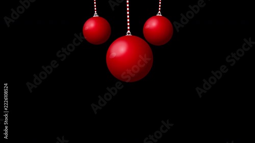 Three red Christmas ornaments hanging on strings against a dark background