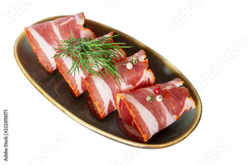 Rolled Slices of Cured Seasoned Pork Neck with Fresh Dill Isolated on White Background.