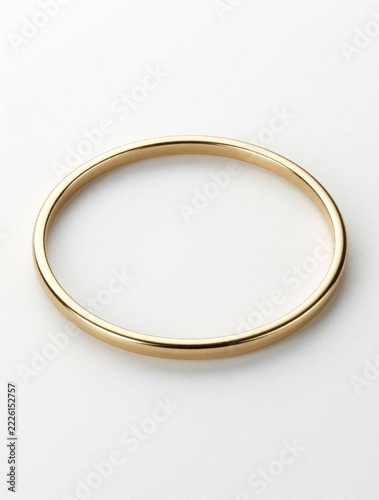 Minimalist gold bangle ring isolated on white background. Thin shiny metallic jewelry piece for luxury fashion design. Elegant circular bracelet for branding wedding mockup. Simple precious metal