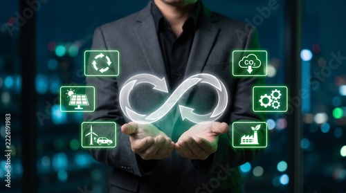 Businessman holding circular economy concept with environmental sustainability icons