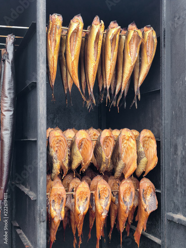 Smoked Fish Hanging in Traditional Smokehouse Rack Ready for Sale or Storage
