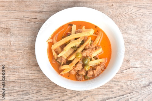 spicy boiled slice fresh bamboo shoot with gluten in coconut milk Thai red curry soup vegetarian fusion food on bowl