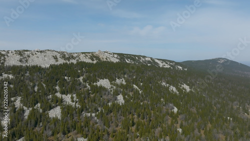 Obraz na plátně A sweeping overhead view reveals rugged rock outcrops above dense taiga woodland