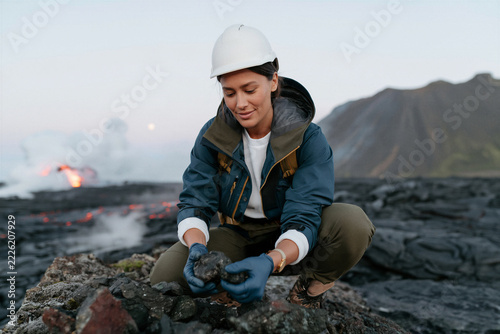 Volcanic Field Researcher Collecting Rock Samples Near Lava Flow