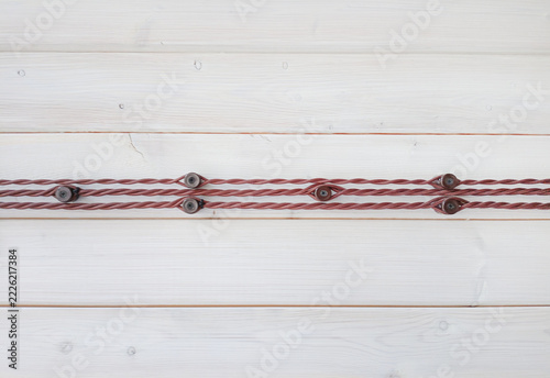 electrical wiring on the wall of wooden house, closeup of photo