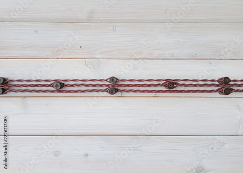 electrical wires on the wall of wooden house, closeup of photo