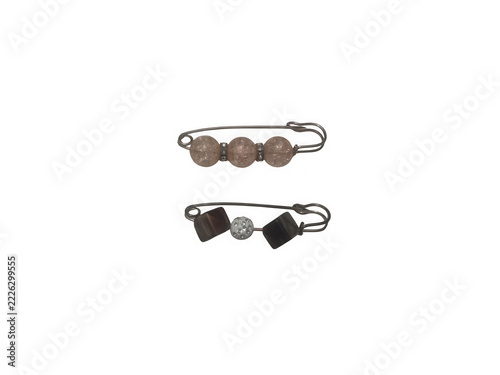 Two decorative safety pins with assorted beads isolated