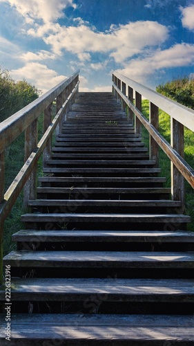 A photograph of a staircase leading toward total relaxation on a North Sea beach—a 