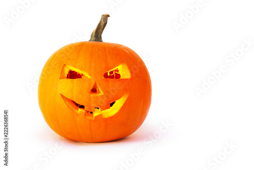 Happy smiling Halloween pumpkin jack o lantern with glowing light inside on white background with copy space for text
