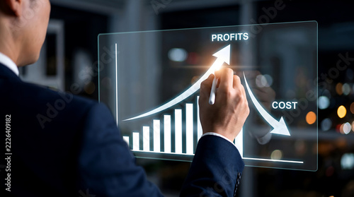 Businessman using a stylus to draw an upward trending profit and cost chart