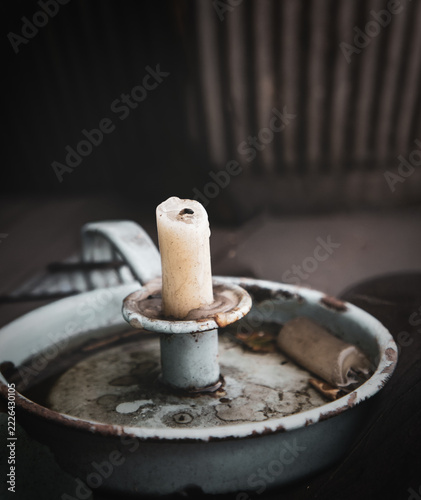 Partly Burnt Candle In A Vintage Rusted Holder