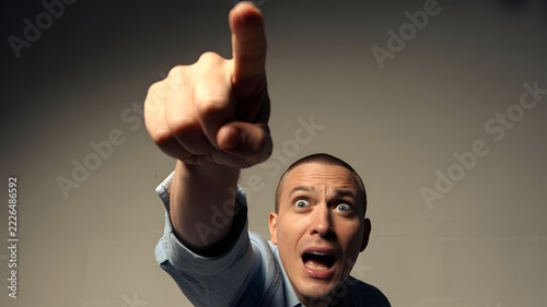 Person pointing with an index finger in an expressive gesture directing attention and indicating a direction for communication and promotional concepts with a bold visual emphasis on the hand movement