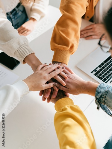 Group of Five Hands Forming Fist Bump Circle, Collaboration and Solidarity